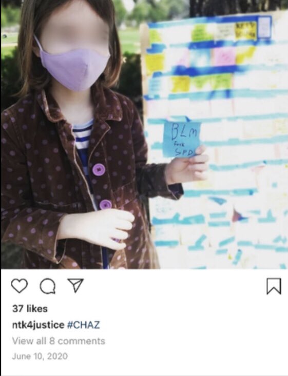 Nicole Thomas-Kennedy posted picture of daughter with note that reads: "BLM fuck Seattle Police Department"